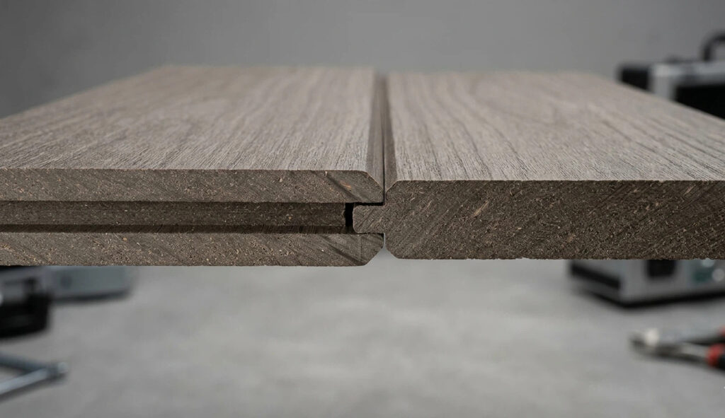 Macro view of a Waterproof Interior Cladding interlocking joint, showing the precision tongue and groove system for a grout-free shower wall panels installation.