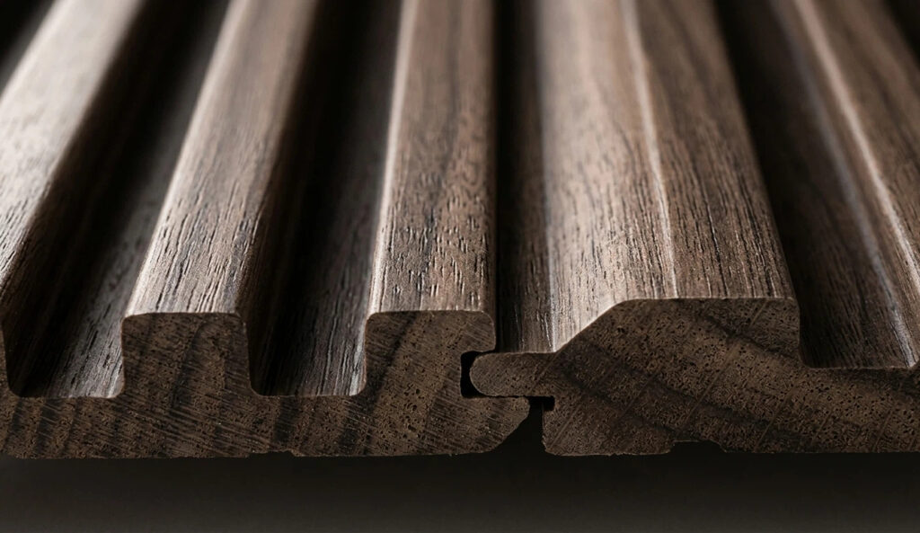 Macro close-up of wood texture wall boards showing fluted Great Wall Panels with a seamless interlocking tongue and groove joint system.