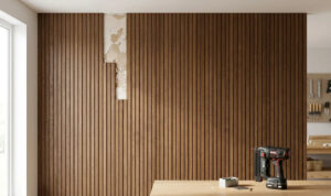 Decorative composite siding covering damaged interior walls, showing the contrast between crumbling old plaster and modern wood slat wall paneling.